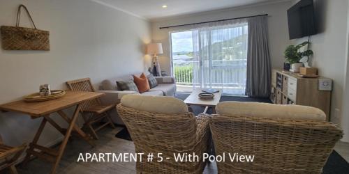 a living room with a couch and a table at Stay n Play n Russell in Russell