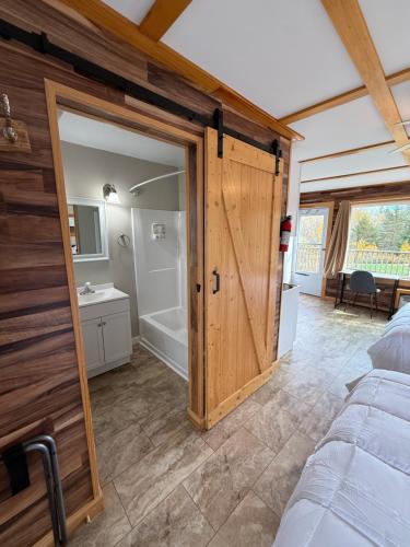 a bedroom with a door leading to a bathroom at Eden Village Motel and Cottages in Bar Harbor