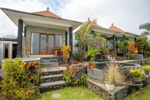 a house with a bunch of plants in front of it at Break Villa Kintamani in Kintamani