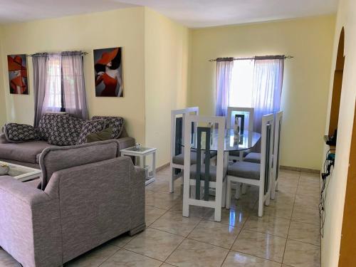 een woonkamer met een bank en een tafel bij Tu Casa En Pedernales in Pedernales