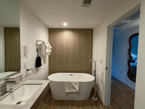 a white bathroom with a tub and a sink at The Sierra House in Mammoth Lakes