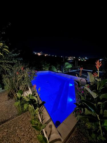 a blue swimming pool at night with a view at Sierra Alta Carlos Paz in Villa Carlos Paz