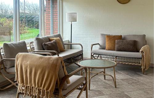 a living room with couches and chairs and a table at 5 Bedroom Awesome Home In Lemvig in Nørby