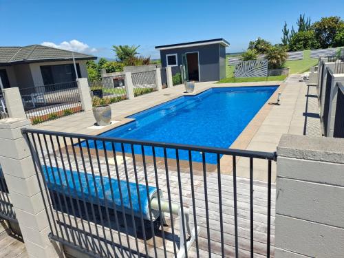 a swimming pool with a fence around it at Little Hurst House - Escape the Ordinary in Inglewood