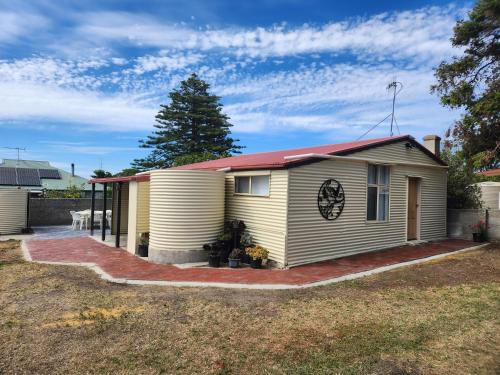 a small yellow house with a red roof at Jack's Shack Kingscote in Kingscote