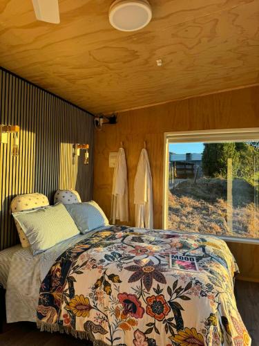 a bedroom with a bed and a large window at Little Hurst House - Escape the Ordinary in Inglewood