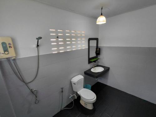 a bathroom with a toilet and a sink at House 2 Bedroom with Seaviews near Haad Rin in Koh Phangan