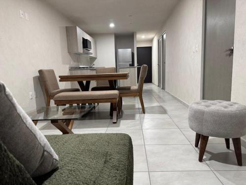 a living room with a dining room table and chairs at New apartment near H. Civil Viejo with A/C in Guadalajara