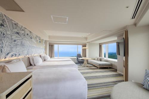 a hotel room with a row of beds at Phoenix Seagaia Ocean Tower in Miyazaki