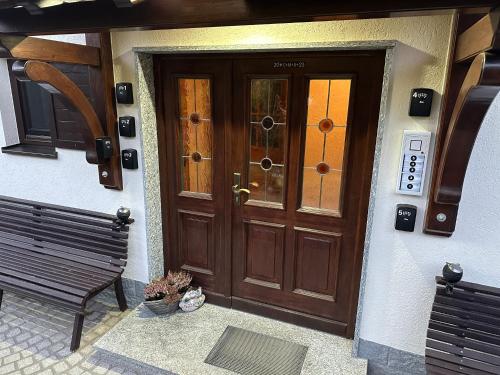 a wooden door of a house with a bench at Haus Monica in Bodenmais