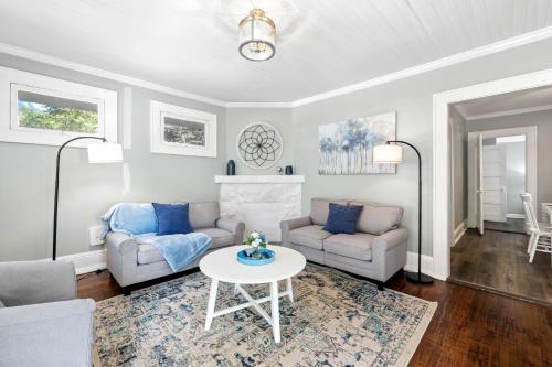a living room with a couch and a table at Hay House- Adorable and updated home! in Fayetteville