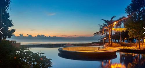a resort with a pool with a view of the ocean at Timurbay Residences in Kuantan