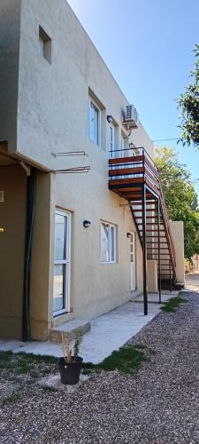 a building with a staircase on the side of it at Brusa3 in Las Grutas
