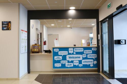 a waiting room with a sign that says welcome at Westlodge Dardilly Lyon Nord in Dardilly