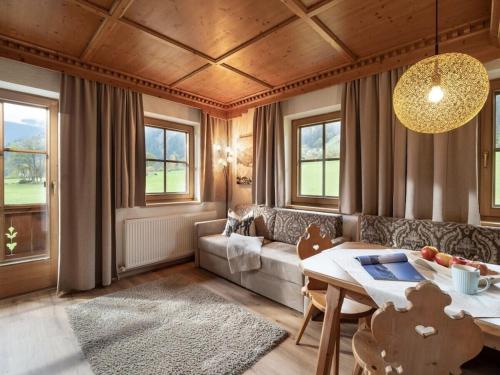 a living room with a couch and a table at Holiday apartment Alpenrose in Huaterhof in Laimach