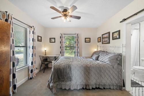 a bedroom with a bed and a ceiling fan at The Riverside Cottage in Dardanelle
