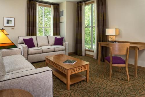 a living room with a couch and a table at The Inn At Swarthmore in Swarthmore