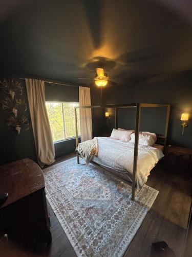 a bedroom with a bed and a large window at North Ga Hideaway in Ranger