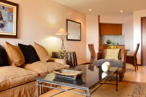 a living room with a couch and a table at Pestana Rovuma in Maputo