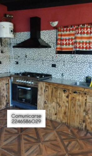 a kitchen with a stove and a counter top at Costero in Santa Teresita