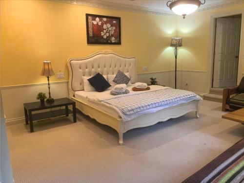 a bedroom with a large white bed in a room at Kerrisdale cozy house in Vancouver