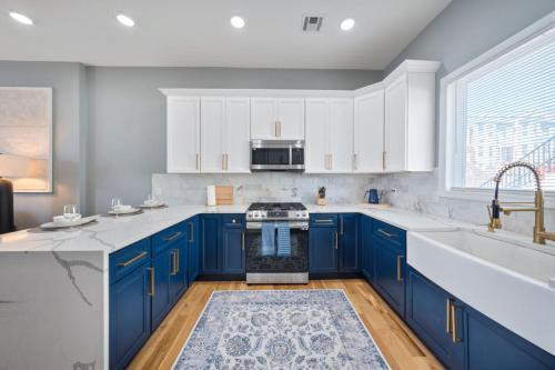 a kitchen with blue cabinets and a sink at NYC Skyline Views • Near Times Sq • Rooftop Deck in Jersey City