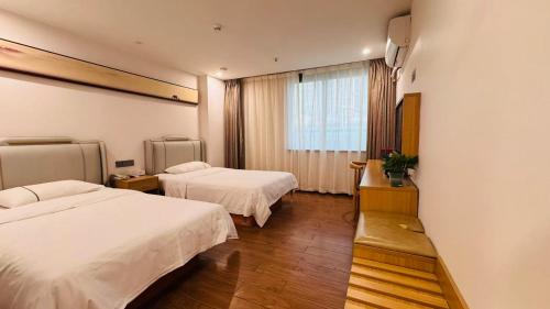 a hotel room with two beds and a window at Park Hyatt Hotel in Taiping