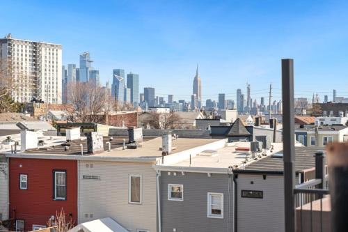 a view of a city skyline with buildings at NYC Skyline Views • Near Times Sq • Rooftop Deck in Jersey City