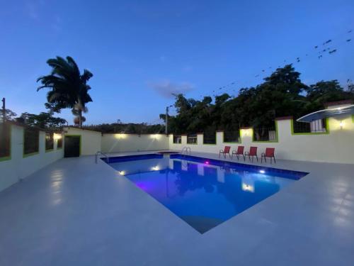 Finca Fusagasugá Villa Luisa في فوساغاسوغا: مسبح وسط مبنى في الليل