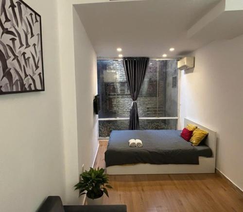 a room with a bed in front of a window at Ha Noi Old Quarter Apartment L'Thao in Hanoi