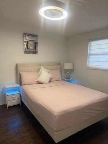 a bedroom with a bed with a light on the ceiling at Luxury&Home in Tampa