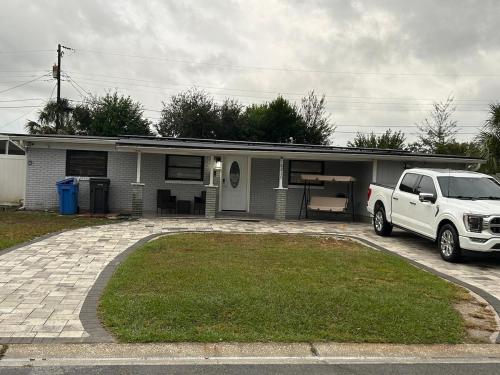 a white truck parked in front of a house at Luxury&Home in Tampa