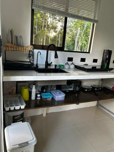 a kitchen counter with a sink and a window at Bungalows Chachagüita in Fortuna