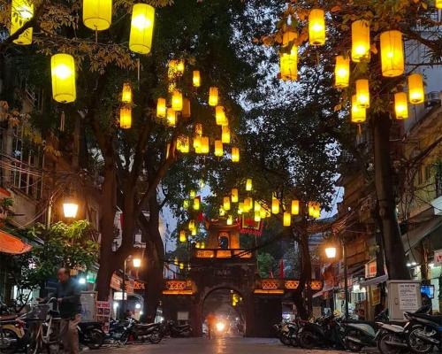a street with a bunch of lights hanging from trees at Ha Noi Old Quarter Apartment L'Thao in Hanoi