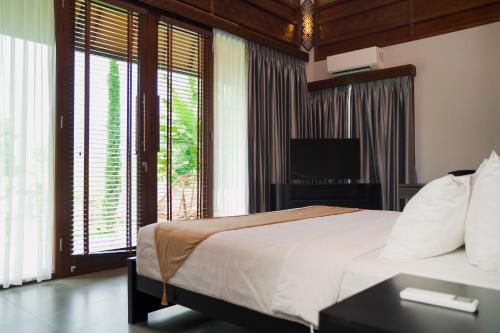 Ένα ή περισσότερα κρεβάτια σε δωμάτιο στο MAHALAYA Garden Resort