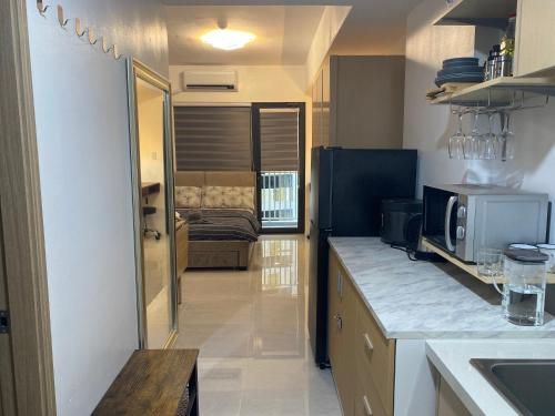 a kitchen with a counter top and a microwave at City Clou in Cebu City