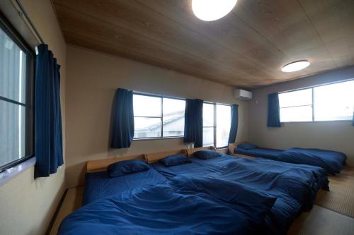 En eller flere senge i et værelse på Ogoto House Rake Omi