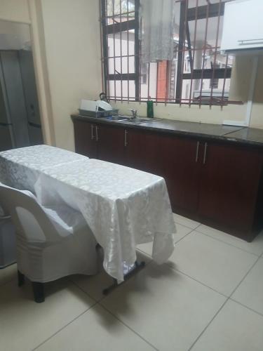 a hospital room with a table with a white blanket on it at Clark lodge at 272 in Durban