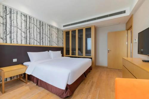 En eller flere senge i et værelse på Starway Hotel Suzhou Shishan Road High-Tech Plaza