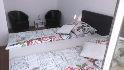 two beds in a room with pillows on them at Vila Ema Apartments and Rooms in Ljubljana