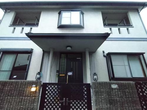 a white house with a front door and windows at Hana88 in Otsu