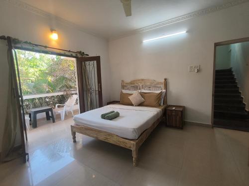 a bedroom with a bed in a room with a staircase at Villa NAMAKA in Morjim
