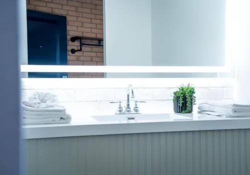 a bathroom counter with a sink and a mirror at The Landmark Hotel in Laredo