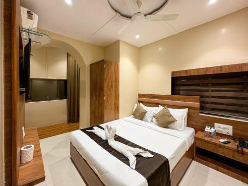 a bedroom with a large bed in a room at Palm Breeze Hotel - Colaba in Mumbai
