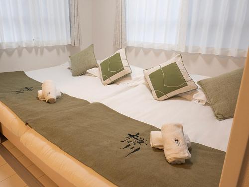 Ένα ή περισσότερα κρεβάτια σε δωμάτιο στο 桜の川50 東京晴空塔10分钟本所吾妻橋駅5分钟5人房丨 Tokyo skytree 10 mins Honjo Azumabashi 5 minutes5 people