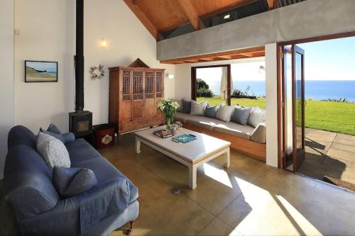 a living room with a couch and a table at The Pah - Stay Waiheke in Onetangi
