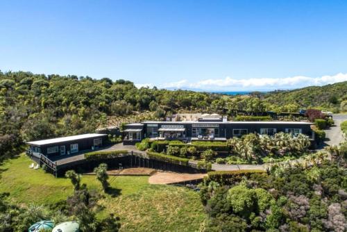 an aerial view of a house with a garden at Delamore Cove - Manuka - Stay Waiheke in Matiatia Bay