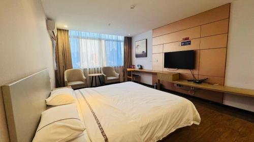 a hotel room with a bed and a desk and a television at Park Hyatt Hotel in Taiping
