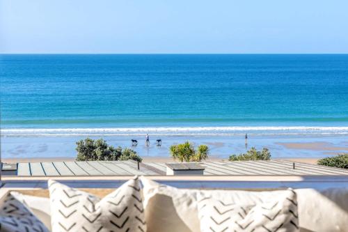 a view of the beach from the balcony of a resort at The Sands Apartment 8 - Stay Waiheke in Waiheke Island