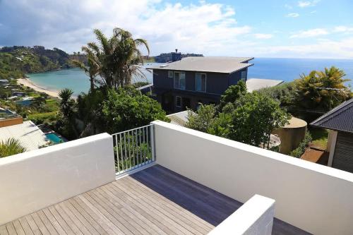 a balcony with a view of the ocean at Number Five - Stay Waiheke in Onetangi
